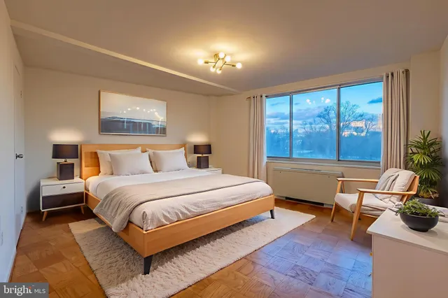 a bedroom with a large bed and a large window