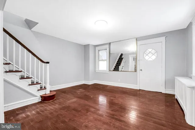a view of kitchen with wooden floor and electronic appliances
