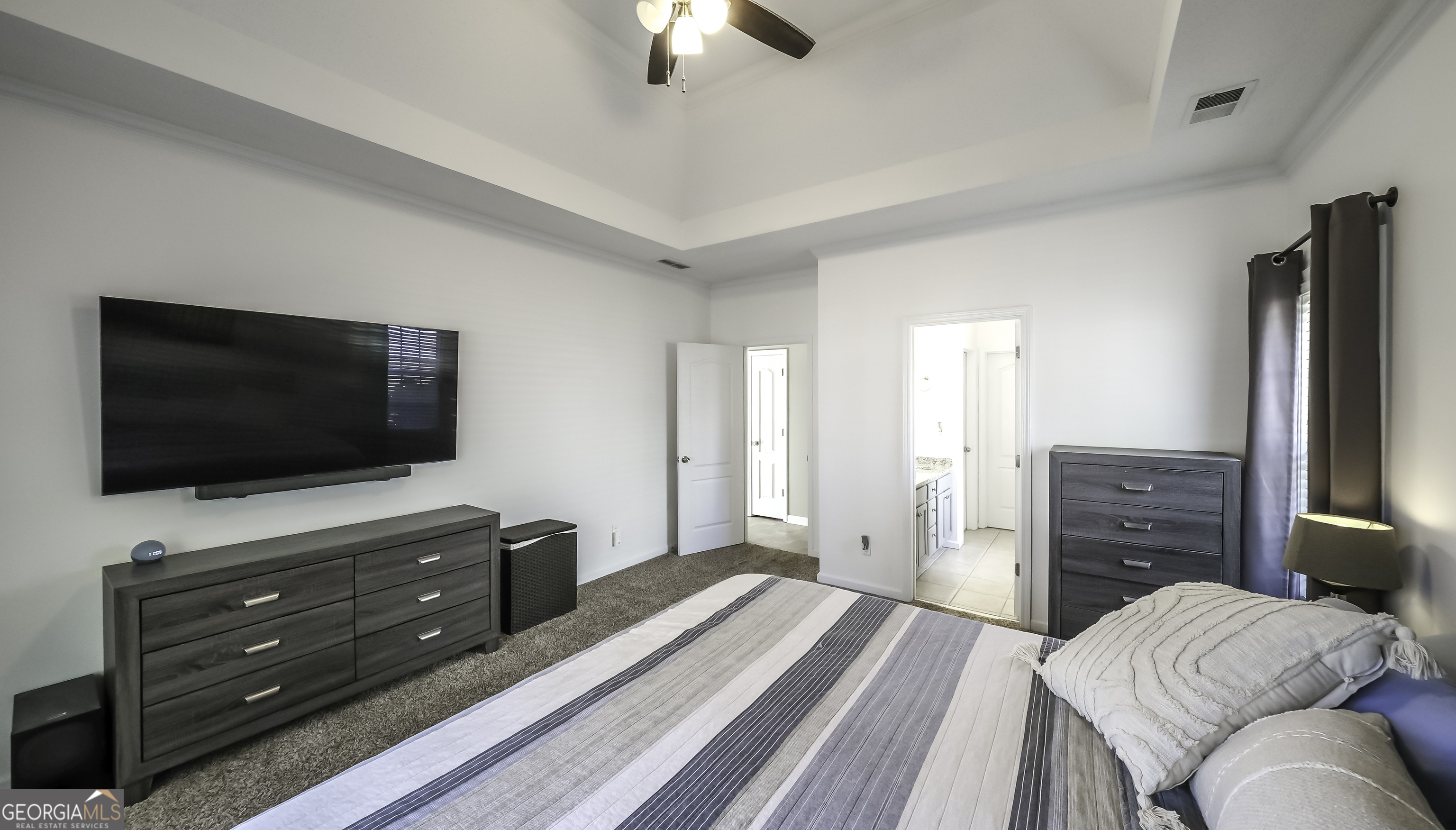 116 Kyle Way Carrollton, GA 30117 - Photo 16 of 30 a bedroom with a bed and a flat screen tv
