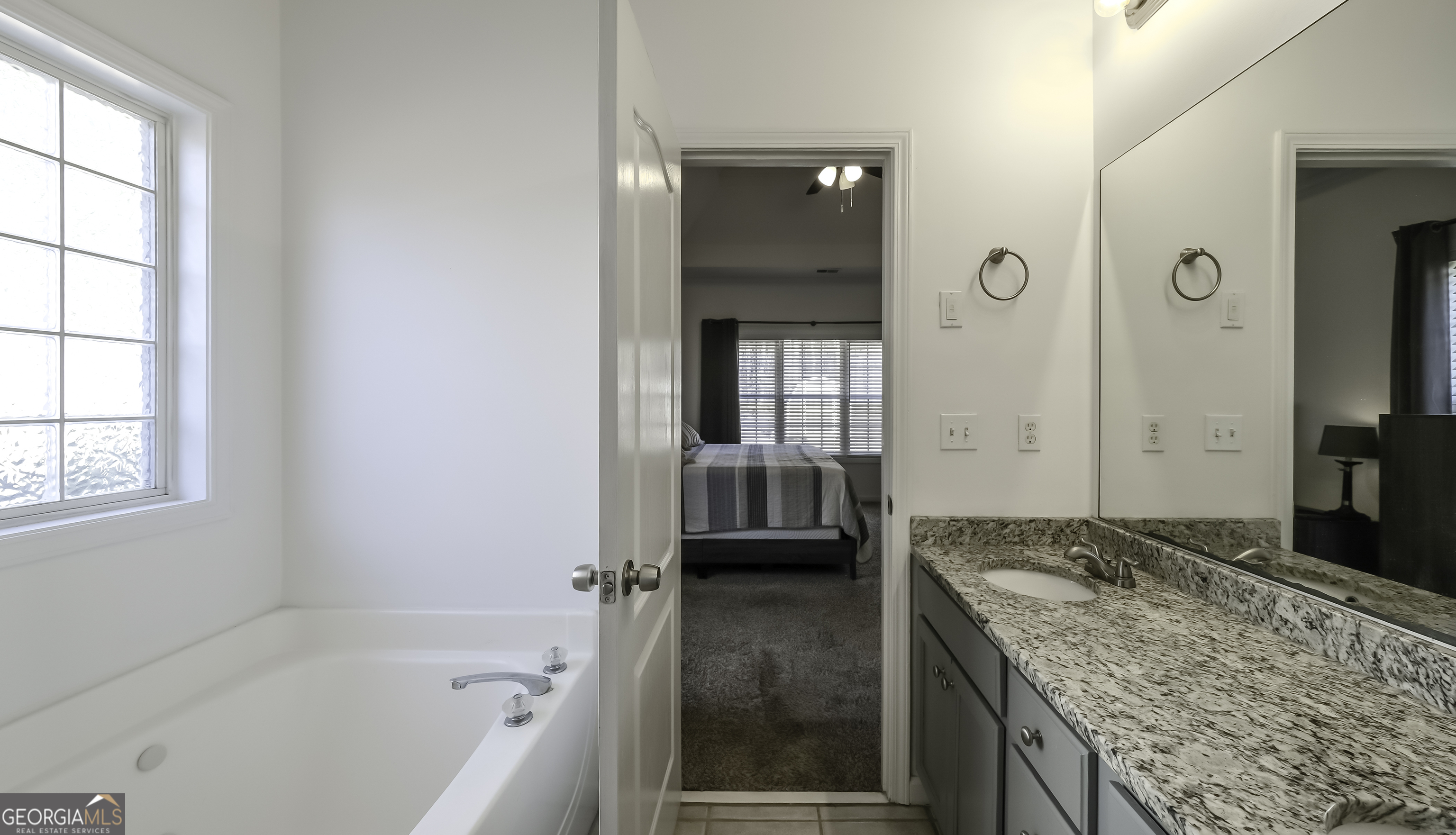 116 Kyle Way Carrollton, GA 30117 - Photo 18 of 30 a bathroom with a granite countertop tub sink and mirror