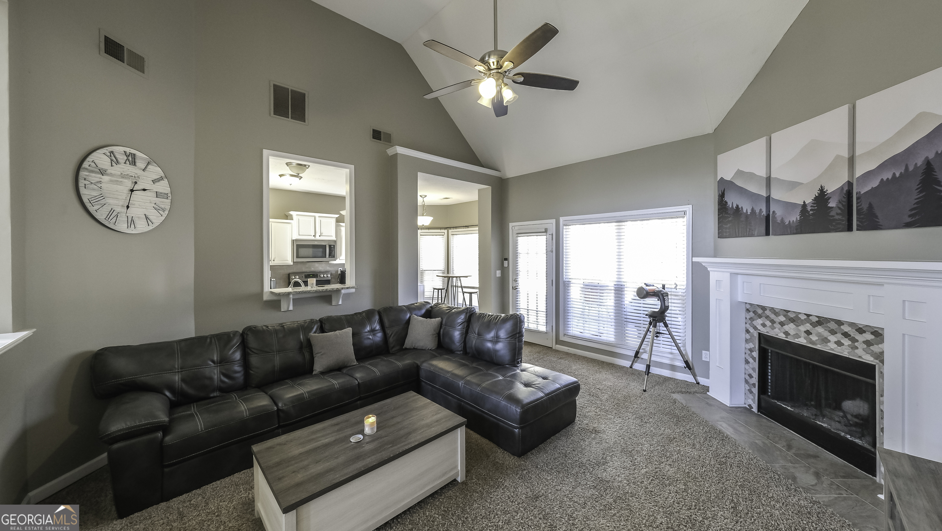 116 Kyle Way Carrollton, GA 30117 - Photo 6 of 30 a living room with furniture a fireplace and a large window