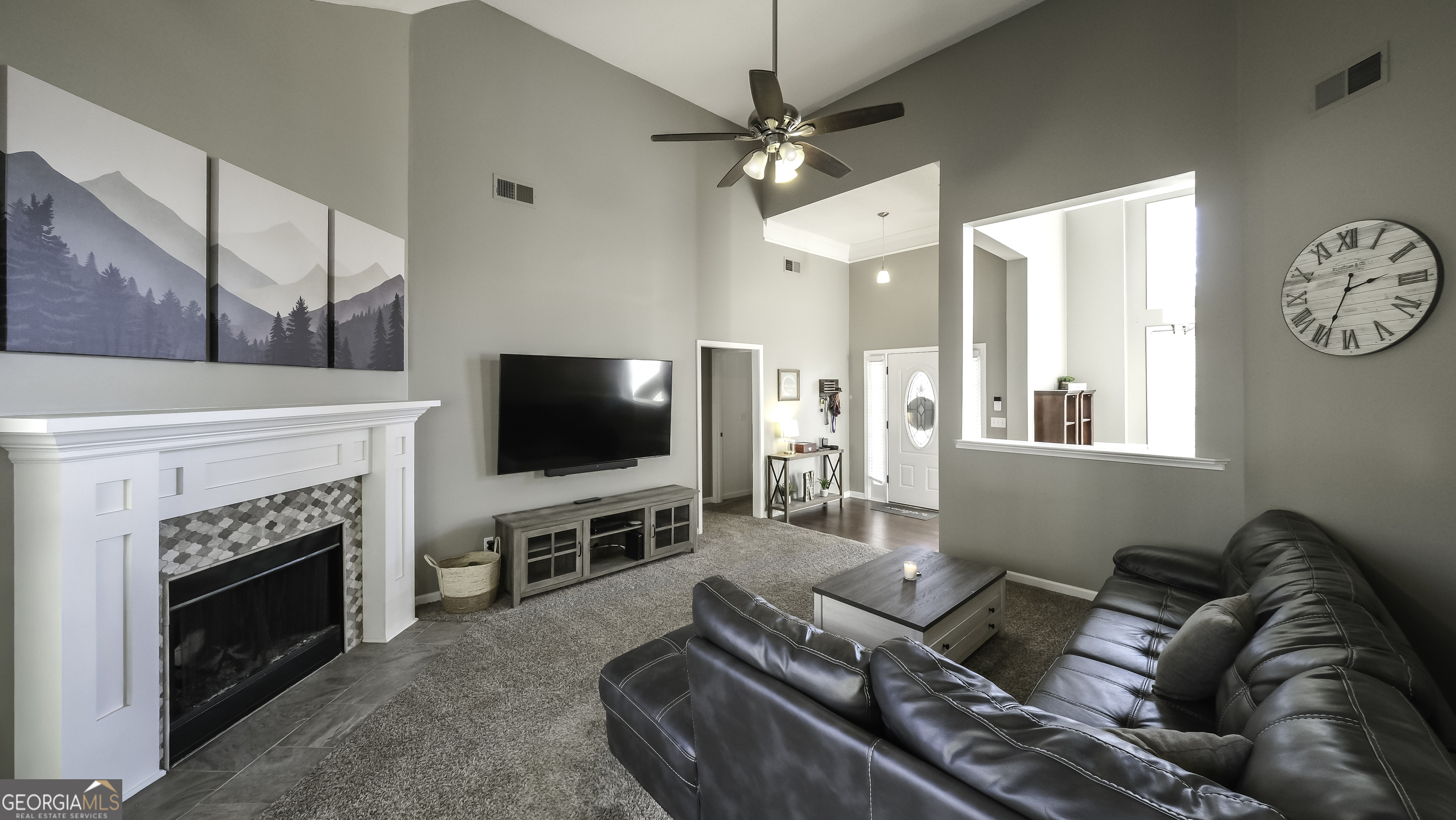 116 Kyle Way Carrollton, GA 30117 - Photo 8 of 30 a living room with furniture a flat screen tv and a fireplace