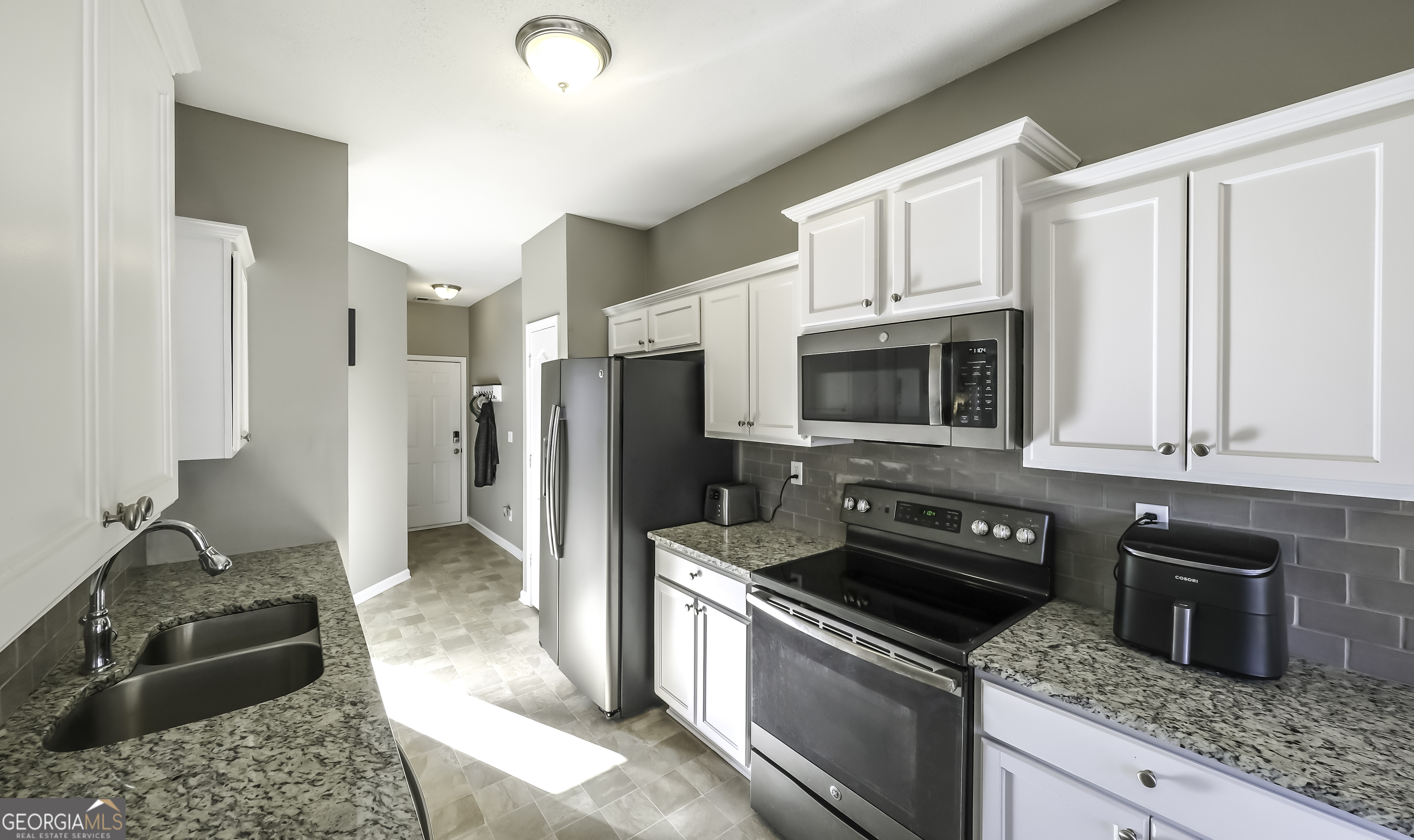 116 Kyle Way Carrollton, GA 30117 - Photo 10 of 30 a kitchen with stainless steel appliances granite countertop a refrigerator stove and sink