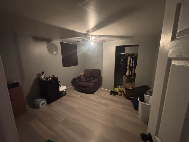 a bedroom with a bed table and a mirror