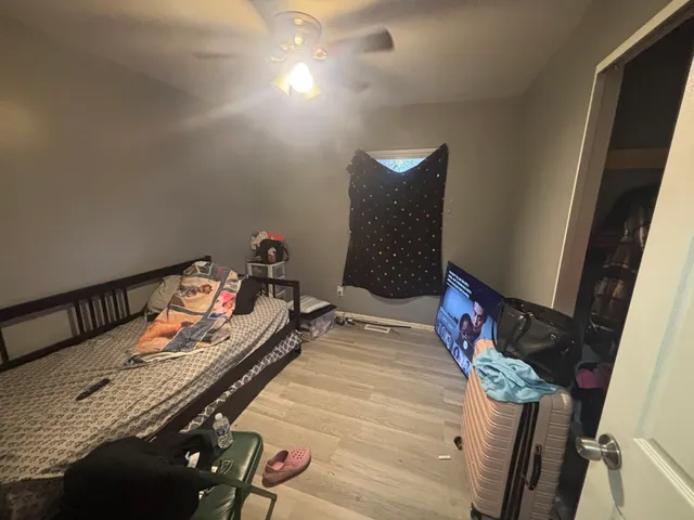 a bedroom with a bed and a window