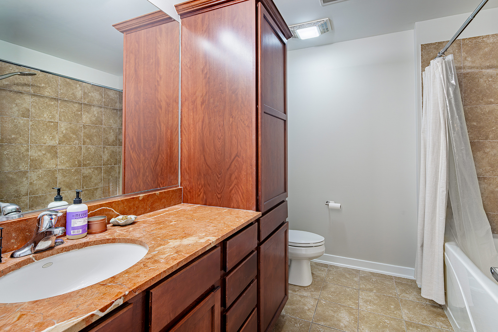 1228 West Monroe Street, Unit 504 Chicago, IL 60607 - Photo 12 of 23 a bathroom with a granite countertop sink toilet and shower