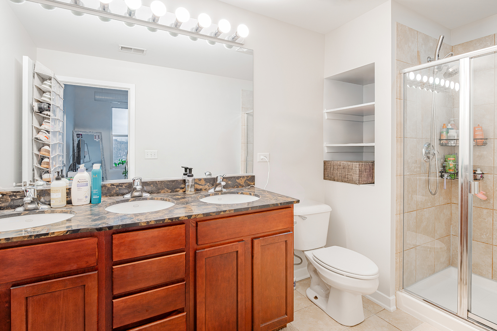1228 West Monroe Street, Unit 504 Chicago, IL 60607 - Photo 16 of 23 a bathroom with a granite countertop sink toilet and shower