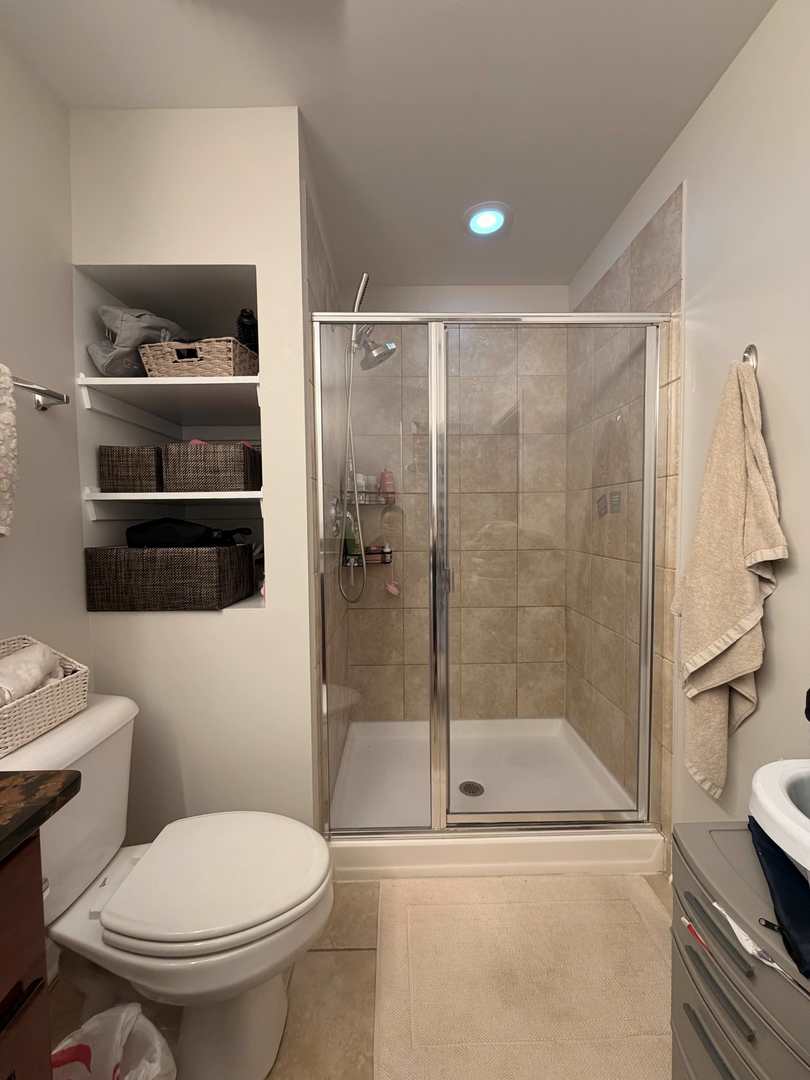 1228 West Monroe Street, Unit 504 Chicago, IL 60607 - Photo 17 of 23 a bathroom with a toilet and a shower