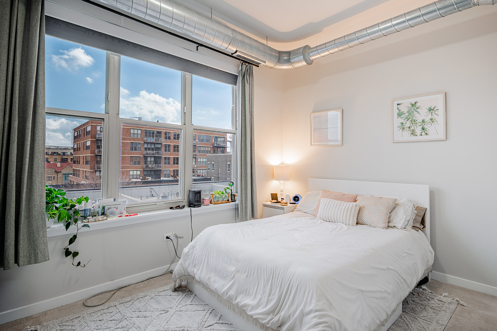 1228 West Monroe Street, Unit 504 Chicago, IL 60607 - Photo 18 of 23 a bedroom with a large bed and a large window