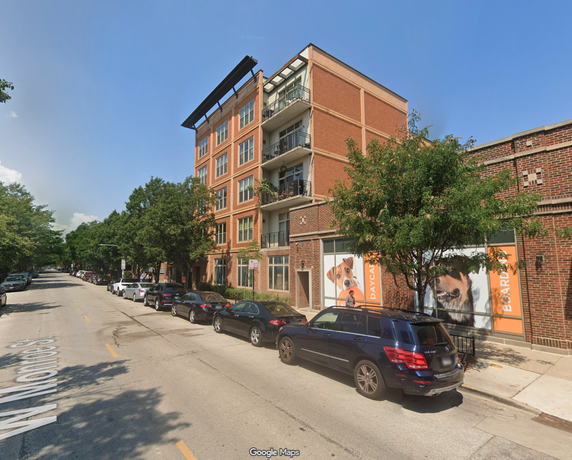 1228 West Monroe Street, Unit 504 Chicago, IL 60607 - Photo 2 of 23 a city street lined with tall buildings and cars