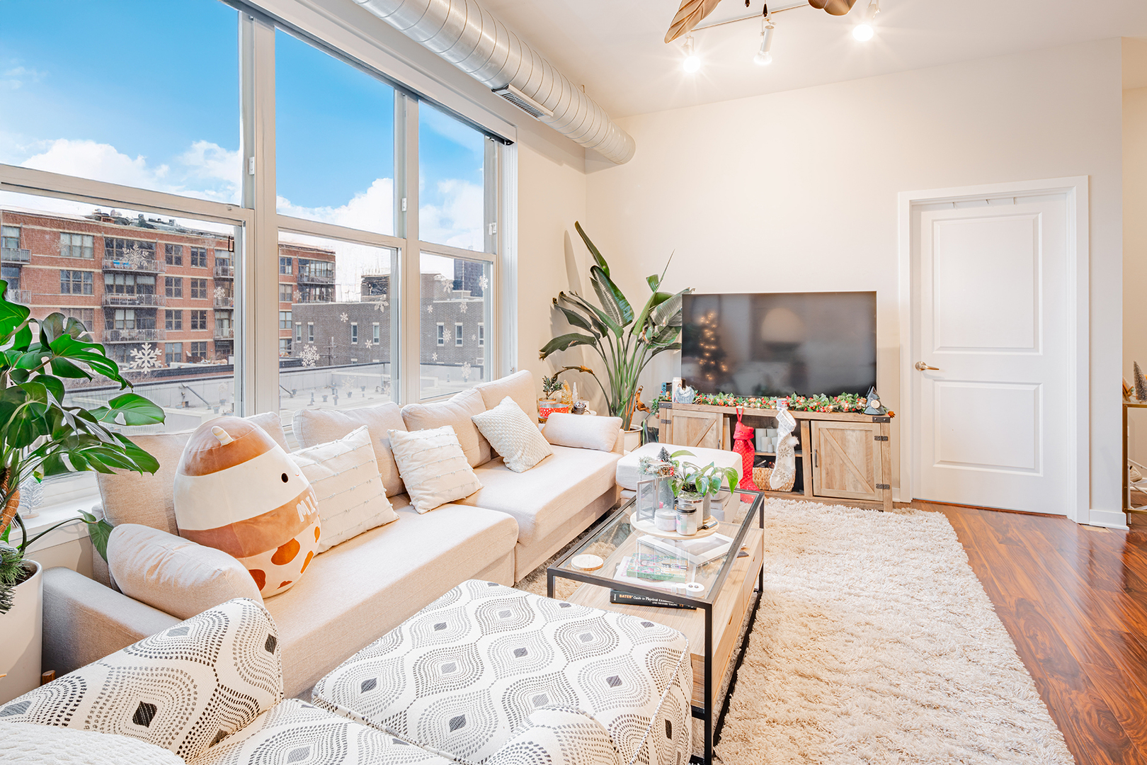 1228 West Monroe Street, Unit 504 Chicago, IL 60607 - Photo 9 of 23 a living room with furniture and a flat screen tv
