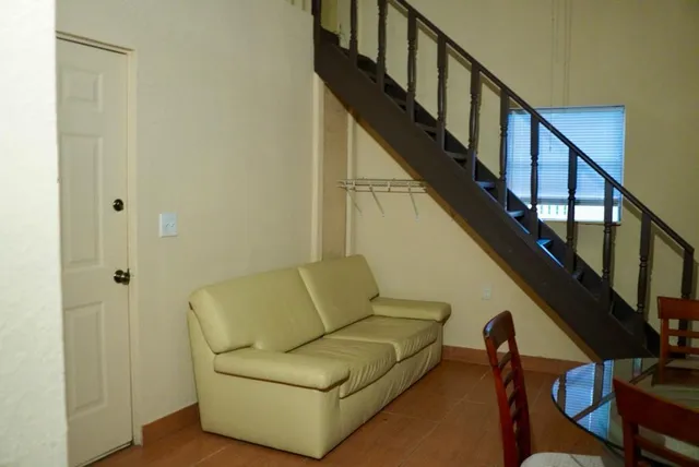 a living room with wooden floors and a glass top table