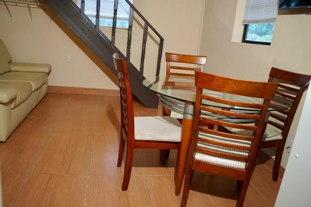 a view of a room with wooden walls and windows