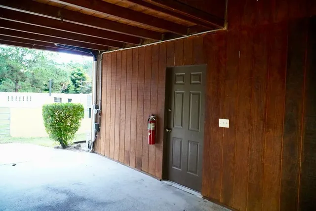 a kitchen with granite countertop a refrigerator and a stove top oven