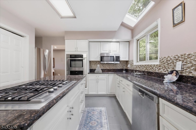 112 Knob Hill Road Hackettstown, NJ 07840 - Photo 11 of 32 a large kitchen with stainless steel appliances granite countertop a stove and a sink