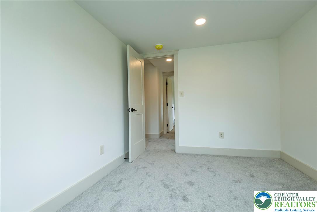 72 Allegheny Road Mount Bethel, PA 18343 - Photo 33 of 72 A well-lit room with recessed lighting and soft carpeting, offering a clean and inviting atmosphere.