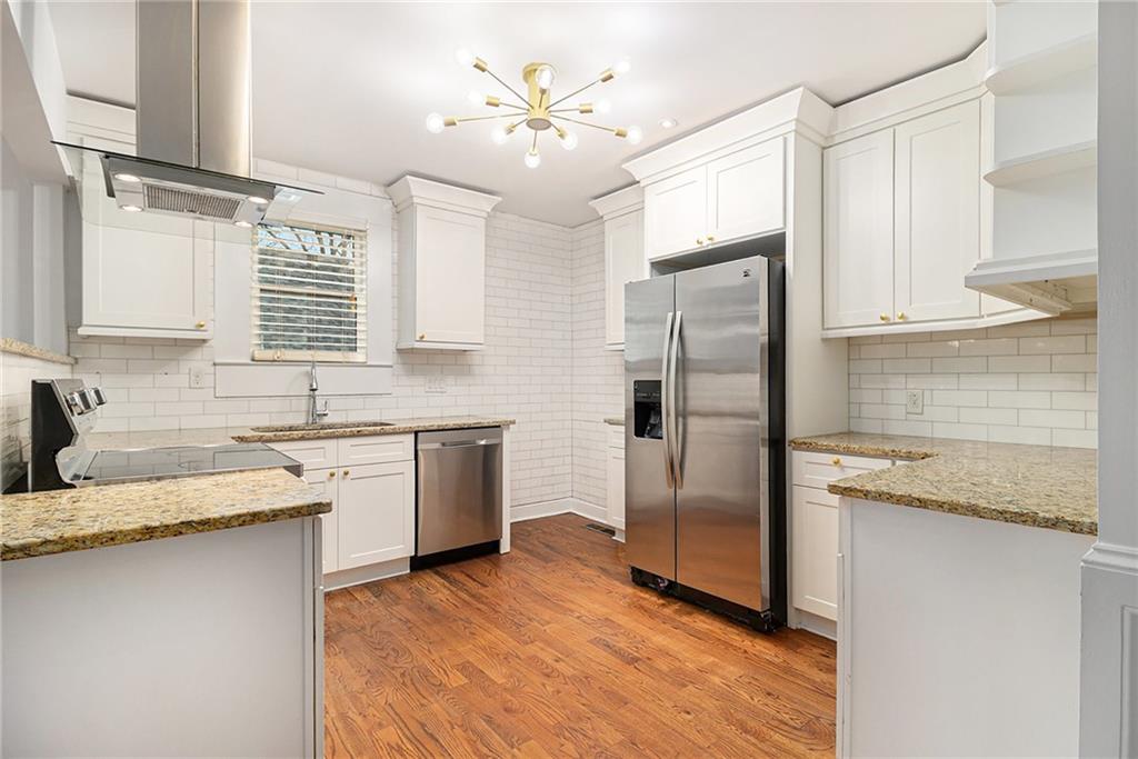 1719 Flat Shoals Road Southeast Atlanta, GA 30316 - Photo 12 of 28 a kitchen with granite countertop a sink stainless steel appliances and cabinets