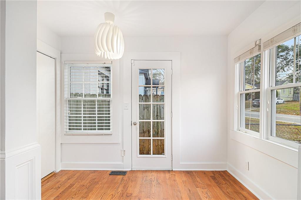 1719 Flat Shoals Road Southeast Atlanta, GA 30316 - Photo 15 of 28 a view of empty room with wooden floor and fan