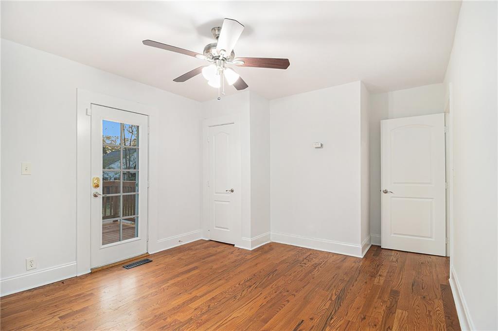 1719 Flat Shoals Road Southeast Atlanta, GA 30316 - Photo 17 of 28 a view of an empty room with wooden floor and a window