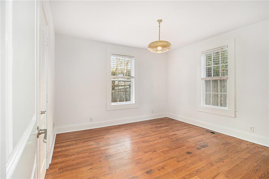 1719 Flat Shoals Road Southeast Atlanta, GA 30316 - Photo 18 of 28 an empty room with wooden floor window and windows