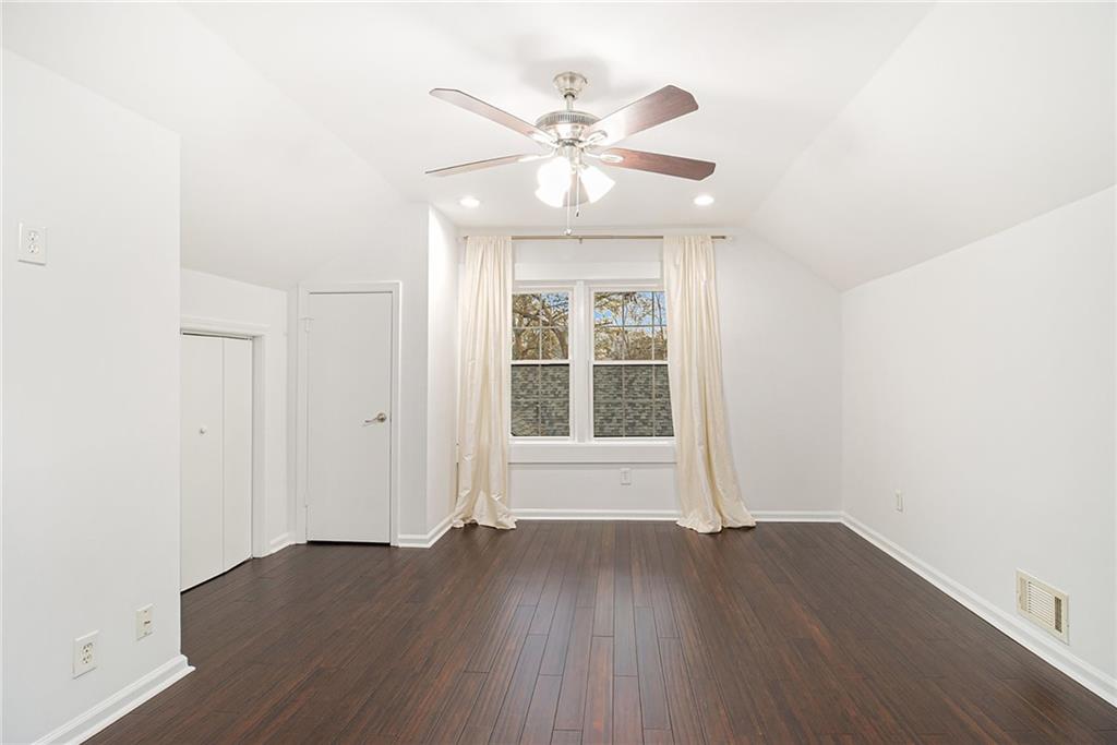 1719 Flat Shoals Road Southeast Atlanta, GA 30316 - Photo 20 of 28 an empty room with wooden floor fan and windows
