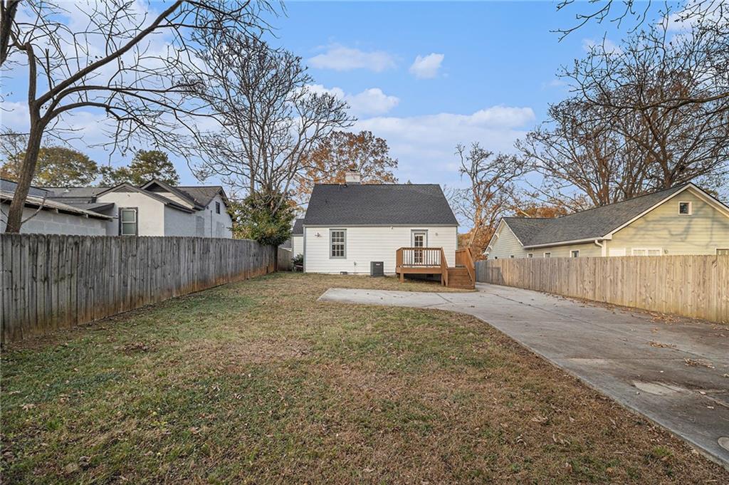1719 Flat Shoals Road Southeast Atlanta, GA 30316 - Photo 2 of 28 a view of a white house in a back yard