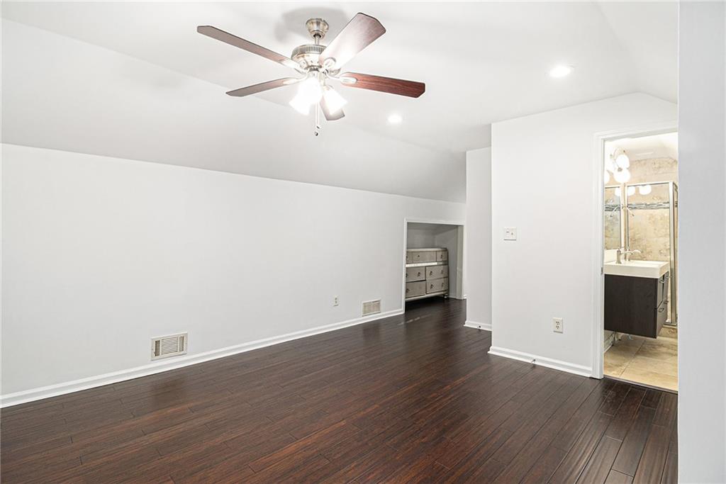 1719 Flat Shoals Road Southeast Atlanta, GA 30316 - Photo 22 of 28 an empty room with wooden floor and windows