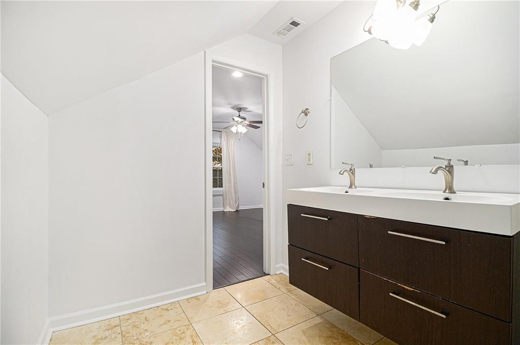 1719 Flat Shoals Road Southeast Atlanta, GA 30316 - Photo 23 of 28 a bathroom with a sink and a mirror