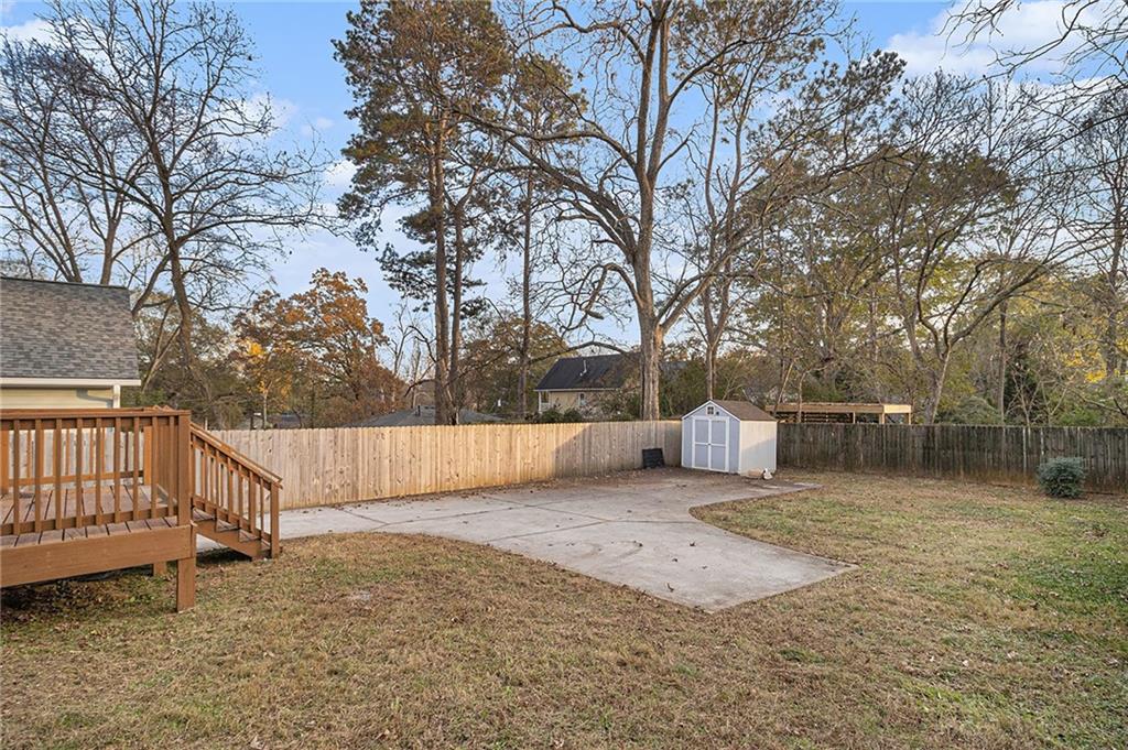 1719 Flat Shoals Road Southeast Atlanta, GA 30316 - Photo 26 of 28 a view of backyard with wooden fence and large trees