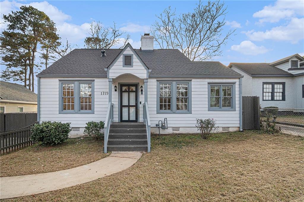 1719 Flat Shoals Road Southeast Atlanta, GA 30316 - Photo 4 of 28 a front view of a house with a yard and garage