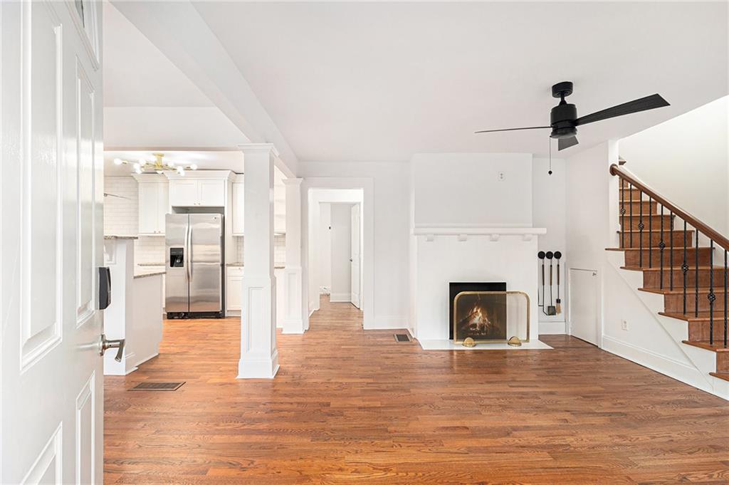 1719 Flat Shoals Road Southeast Atlanta, GA 30316 - Photo 5 of 28 a view of a livingroom with a fireplace wooden floor and windows