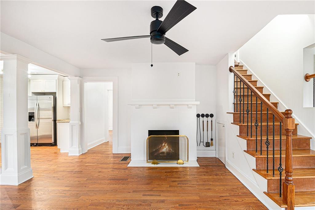 1719 Flat Shoals Road Southeast Atlanta, GA 30316 - Photo 6 of 28 a view of an empty room with wooden floor fireplace and a window