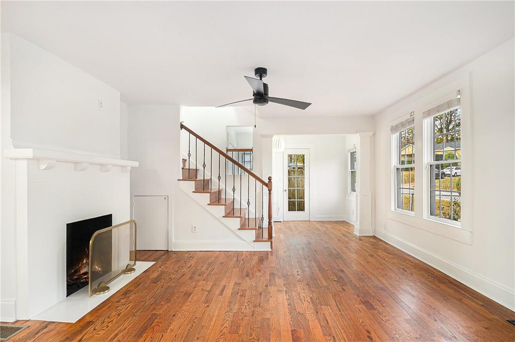 1719 Flat Shoals Road Southeast Atlanta, GA 30316 - Photo 7 of 28 a view of an empty room with wooden floor fireplace and a window