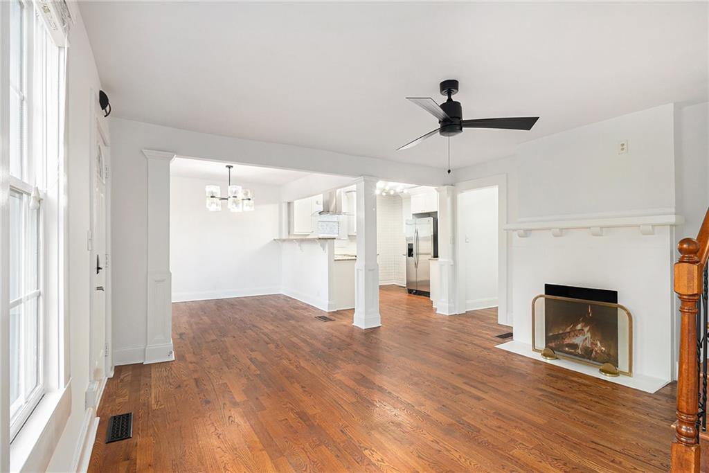 1719 Flat Shoals Road Southeast Atlanta, GA 30316 - Photo 8 of 28 a view of empty room with wooden floor and fireplace