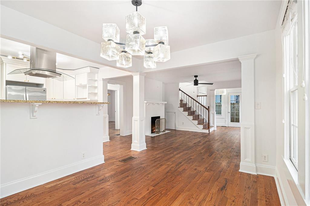 1719 Flat Shoals Road Southeast Atlanta, GA 30316 - Photo 10 of 28 a view of a room with wooden floor fireplace and windows