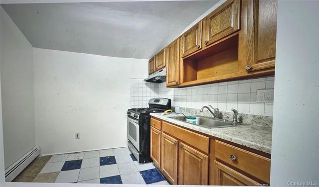 a kitchen with stainless steel appliances granite countertop a sink and a stove top oven