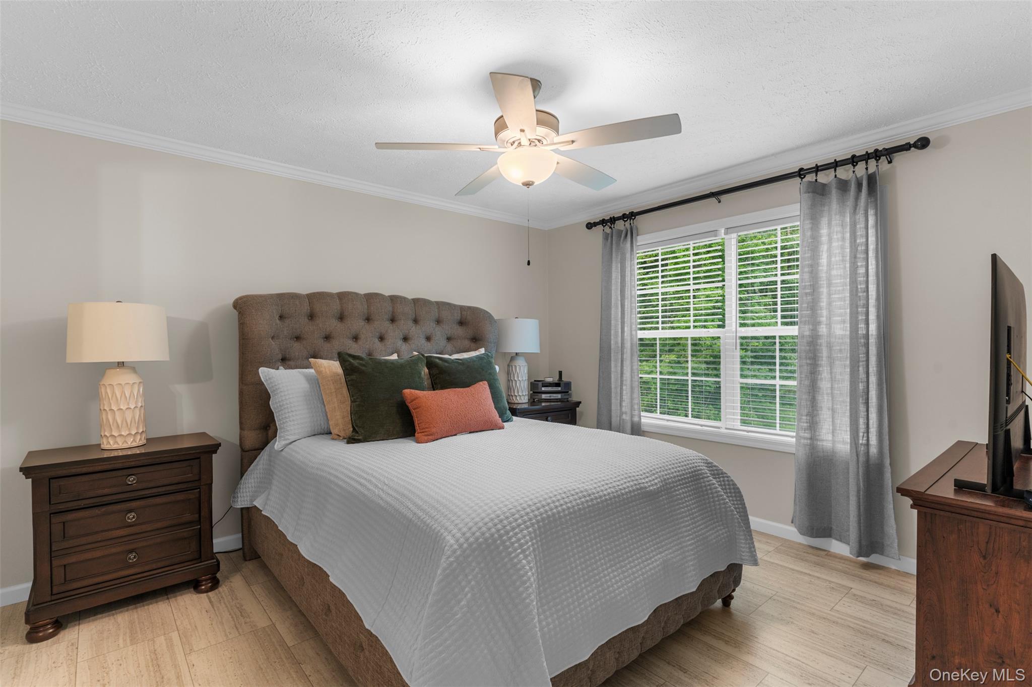 242 Ruby Road, Unit 18 Kingston, NY 12401 - Photo 14 of 23 a bedroom with a bed and a flat tv screen on a dresser