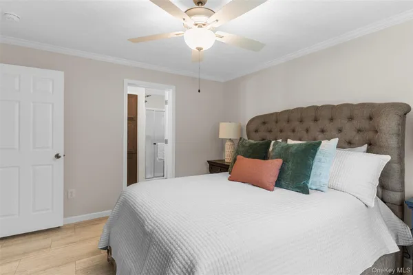 a bedroom with a bed and a ceiling fan