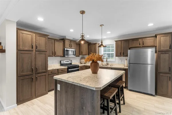 a kitchen with refrigerator a sink and a wooden cabinets