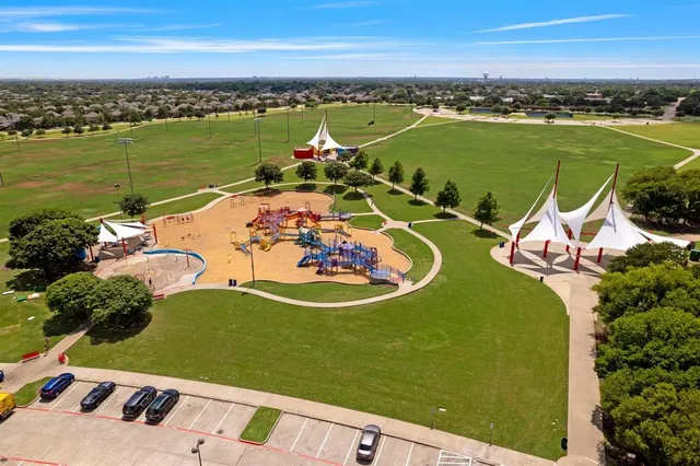 an aerial view of a house with outdoor space lake view and an ocean view