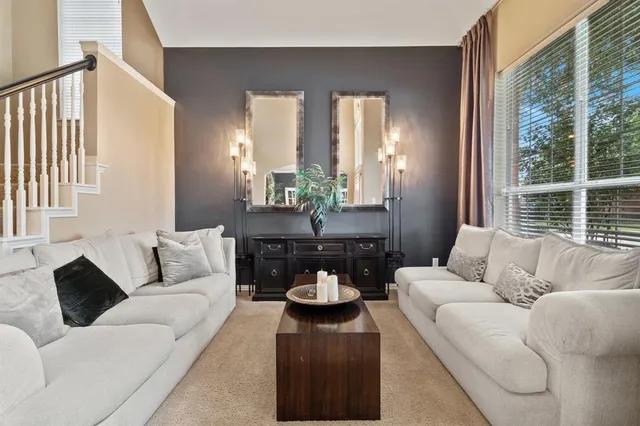 a living room with furniture and a large window