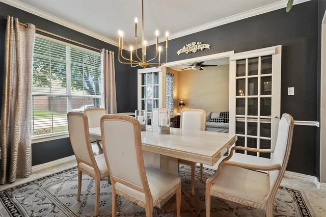 a dining room with furniture a chandelier and wooden floor
