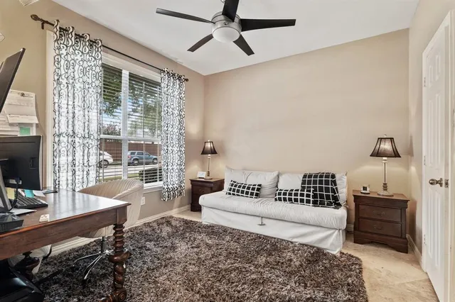 a living room with furniture and a floor to ceiling window