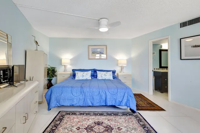 a spacious bedroom with a bed and window