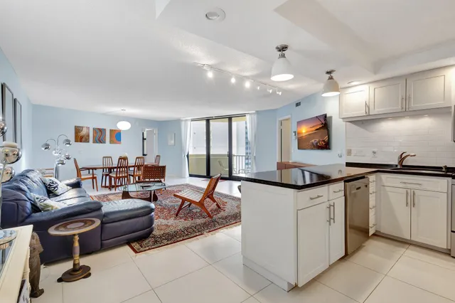 a kitchen with kitchen island stainless steel appliances a sink and cabinets