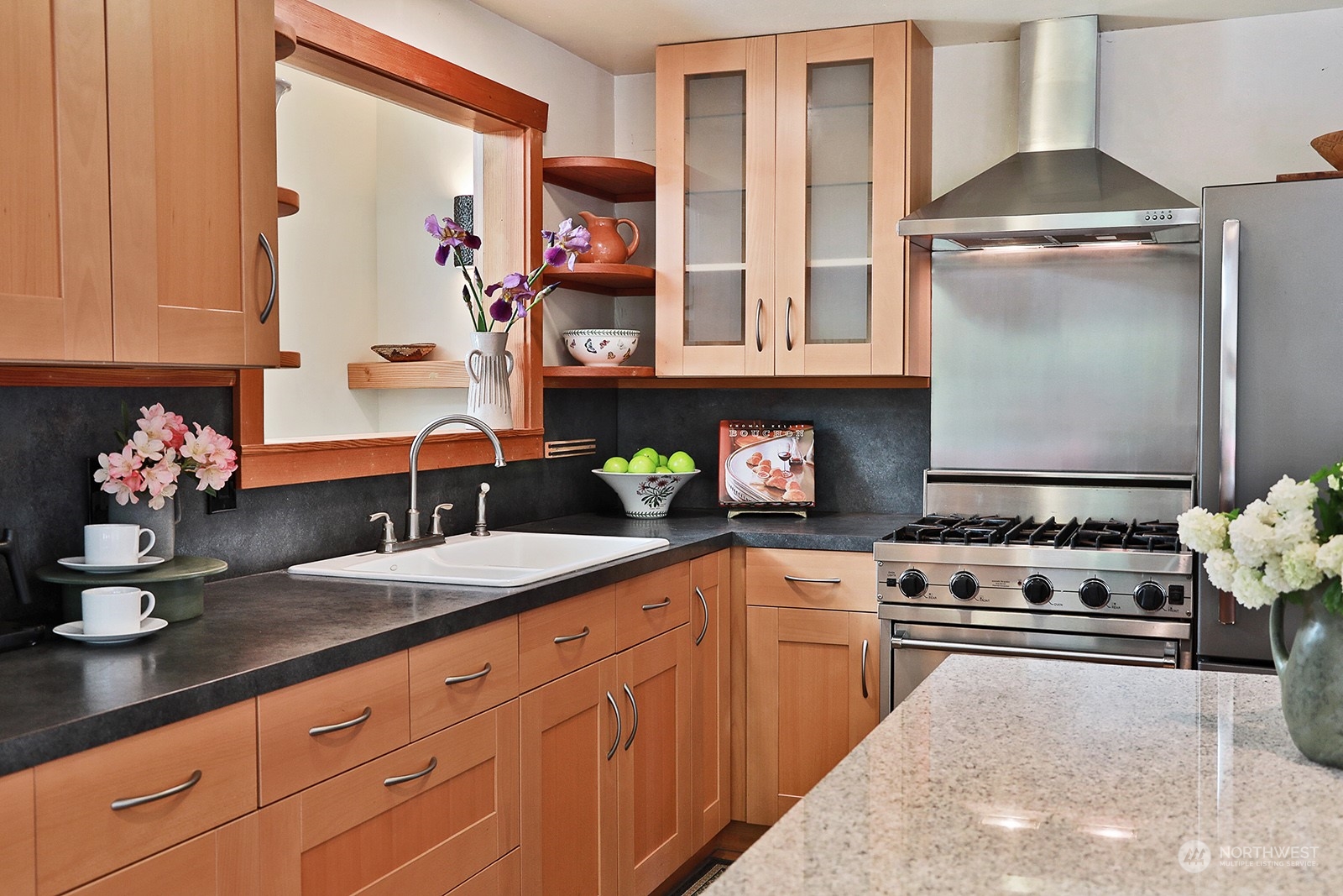 5120 Ribbit Road Langley, WA 98260 - Photo 19 of 40 a kitchen with stainless steel appliances granite countertop a stove and cabinets