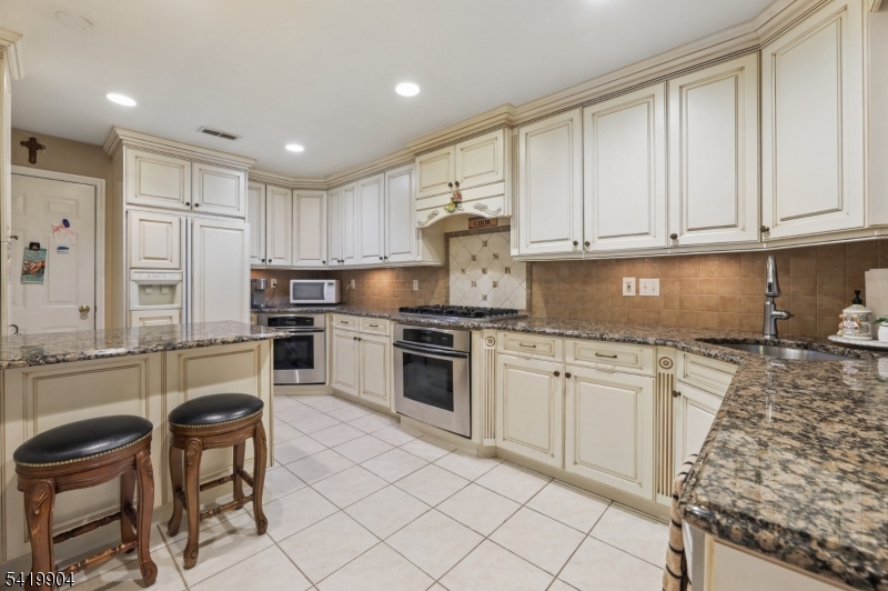 7 Valen Court Franklin Lakes, NJ 07417 - Photo 11 of 32 a kitchen with granite countertop cabinets and steel stainless steel appliances