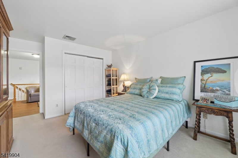 7 Valen Court Franklin Lakes, NJ 07417 - Photo 17 of 32 a bedroom with a large bed and a view of en suite bathroom