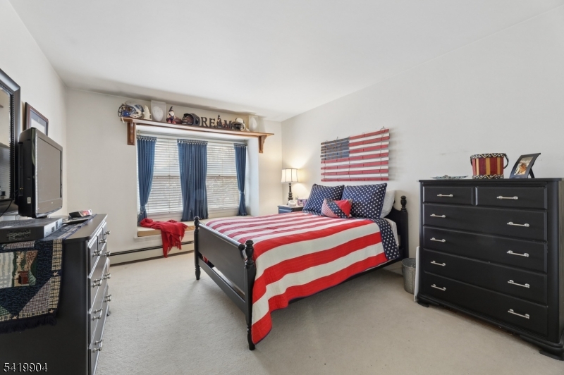 7 Valen Court Franklin Lakes, NJ 07417 - Photo 19 of 32 a bedroom with a bed and flat screen tv