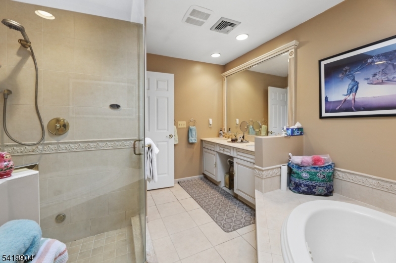 7 Valen Court Franklin Lakes, NJ 07417 - Photo 22 of 32 a bathroom with a tub sink mirror vanity and toilet